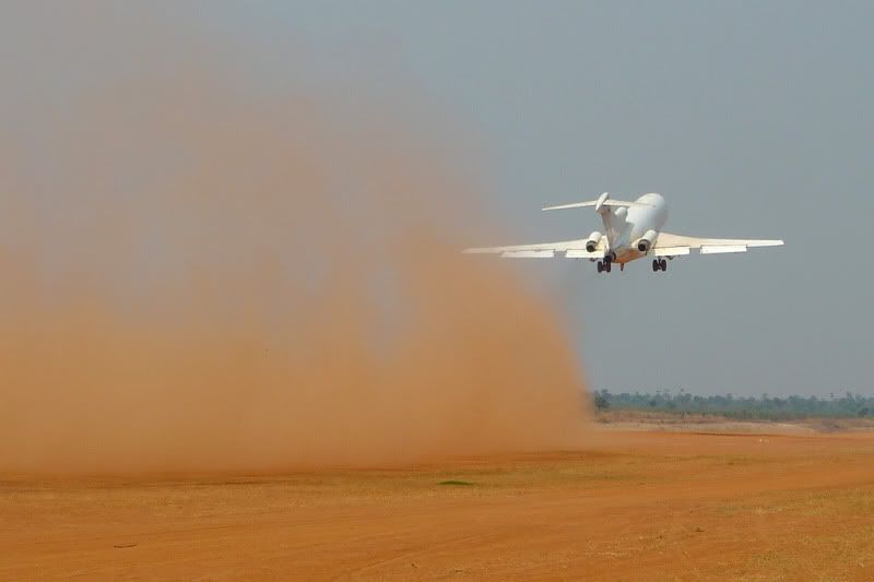 Photo of a 727 taking off from a dirt strip